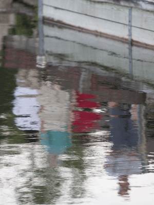 dock figures reflected in bay waters